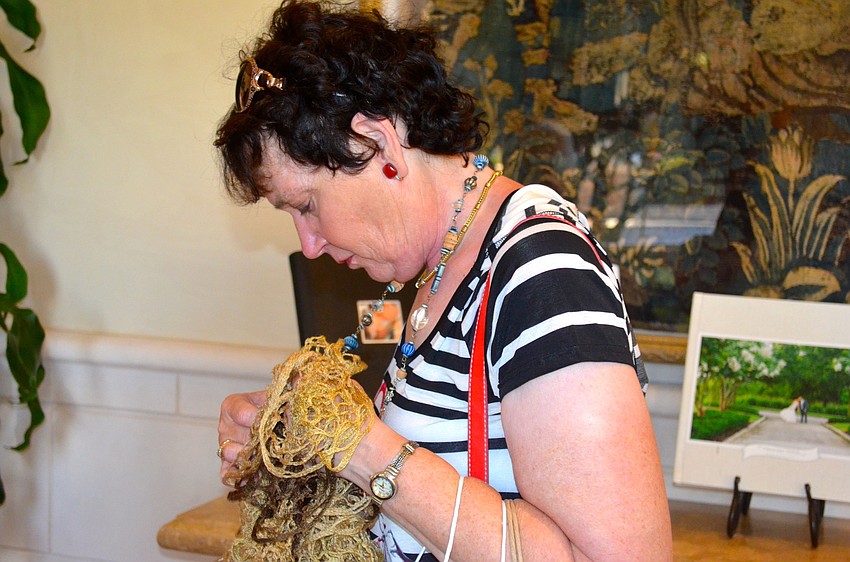 Marilyn Quintal decides which item she will take home.