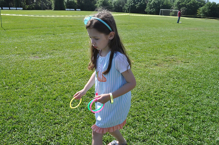 Haley Munson, 5, plays the ring toss.