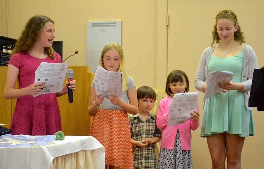 Emma Katz, Shea Casey, Bastien and Charlie Gleeksman, and Andrea Prospect sing â€œFour Questionsâ€ for those in attendance.