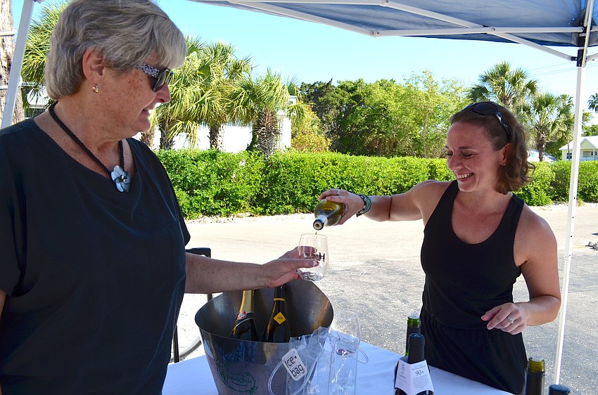 Mary Thibault is poured a wine sample by Carole Decouard.