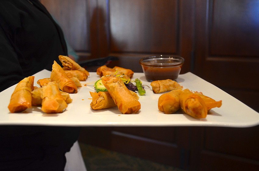 Patrons snacked on chicken spring rolls and other finger foods before dinner.