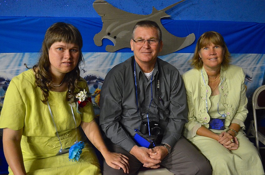Eileen Bond sits with Mike and Colleen Powers.