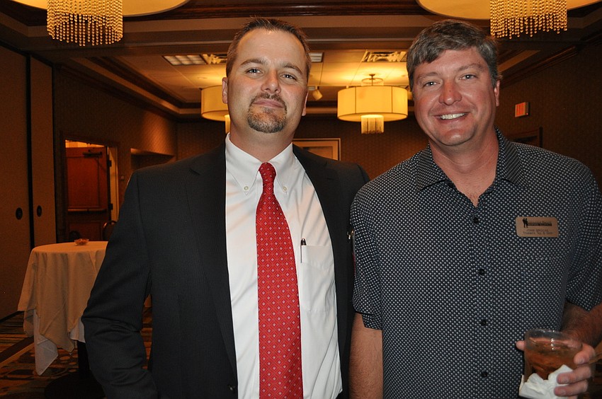 Chris DeLeonardo, a new business alliance member from Wells Fargo Advisers, with John Brocke of Trumanâ€™s Tap and Grill