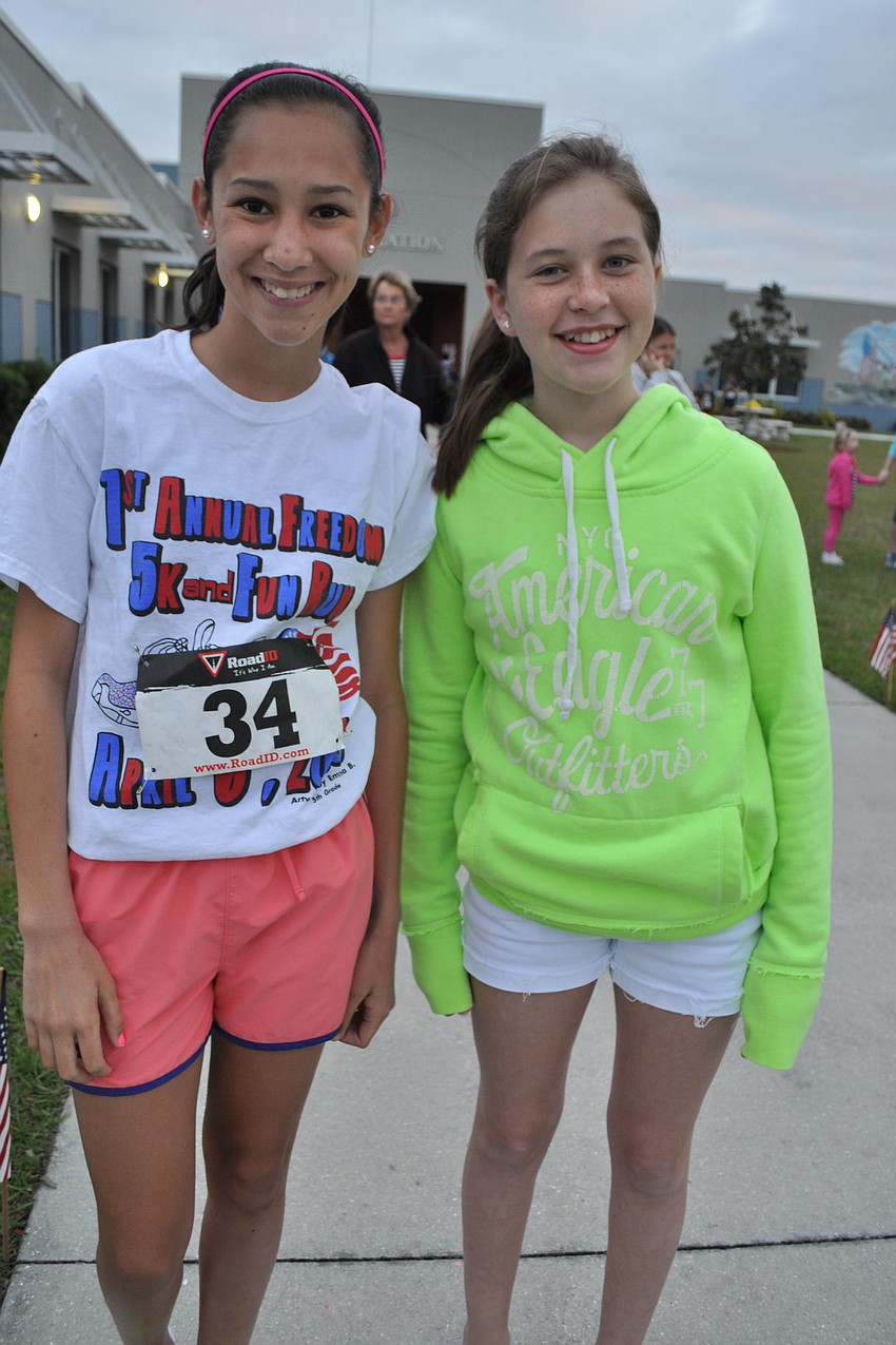 Jenna Mennes ran in the 5K, as her friend, Hallie Madden, watched.