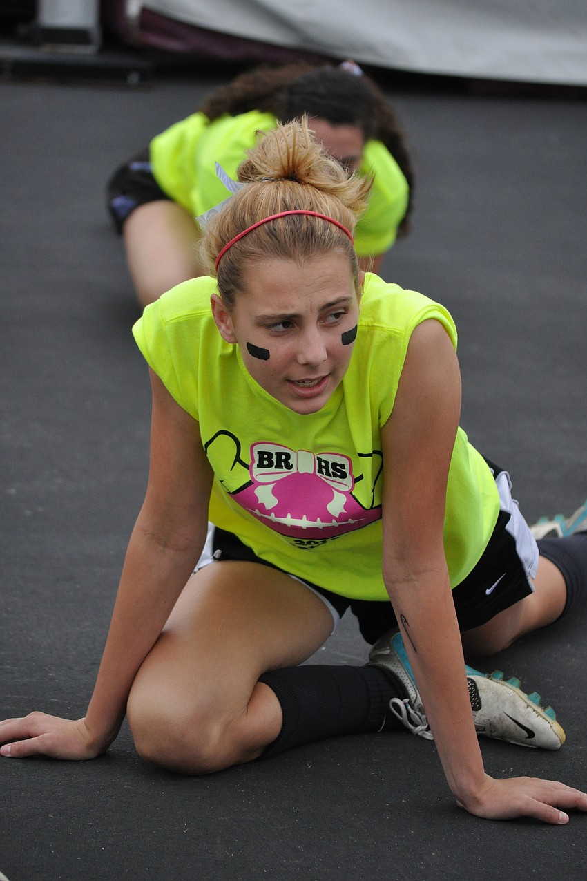 Abigail Holmes, a junior, helps lead her team in some pre-game stretches.