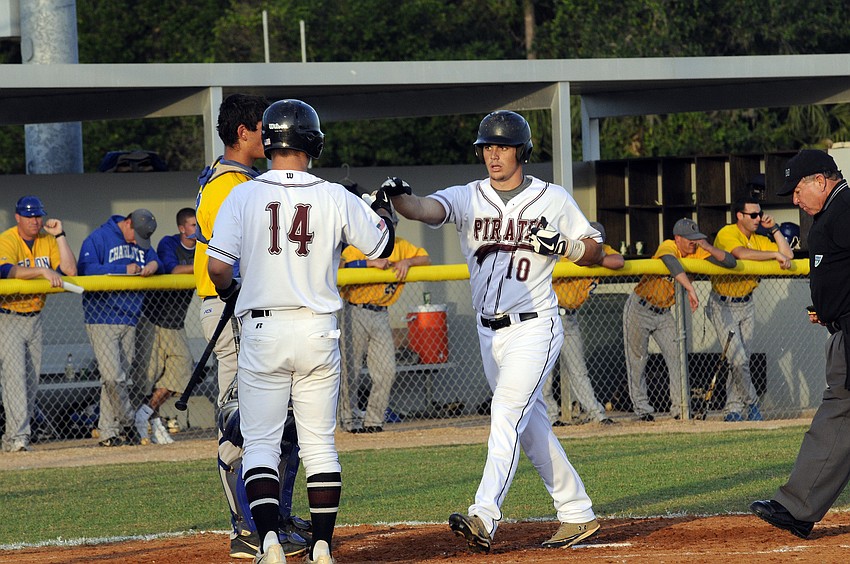 Braden Riverâ€™s Eric Schappacher congratulates Dylan Lee as he crosses home plate following his solo home run in the bottom of the first inning.