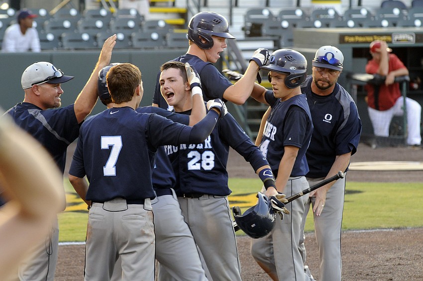 Tyler Dietrich celebrates with his teammates after scoring a run in the top of the second inning.