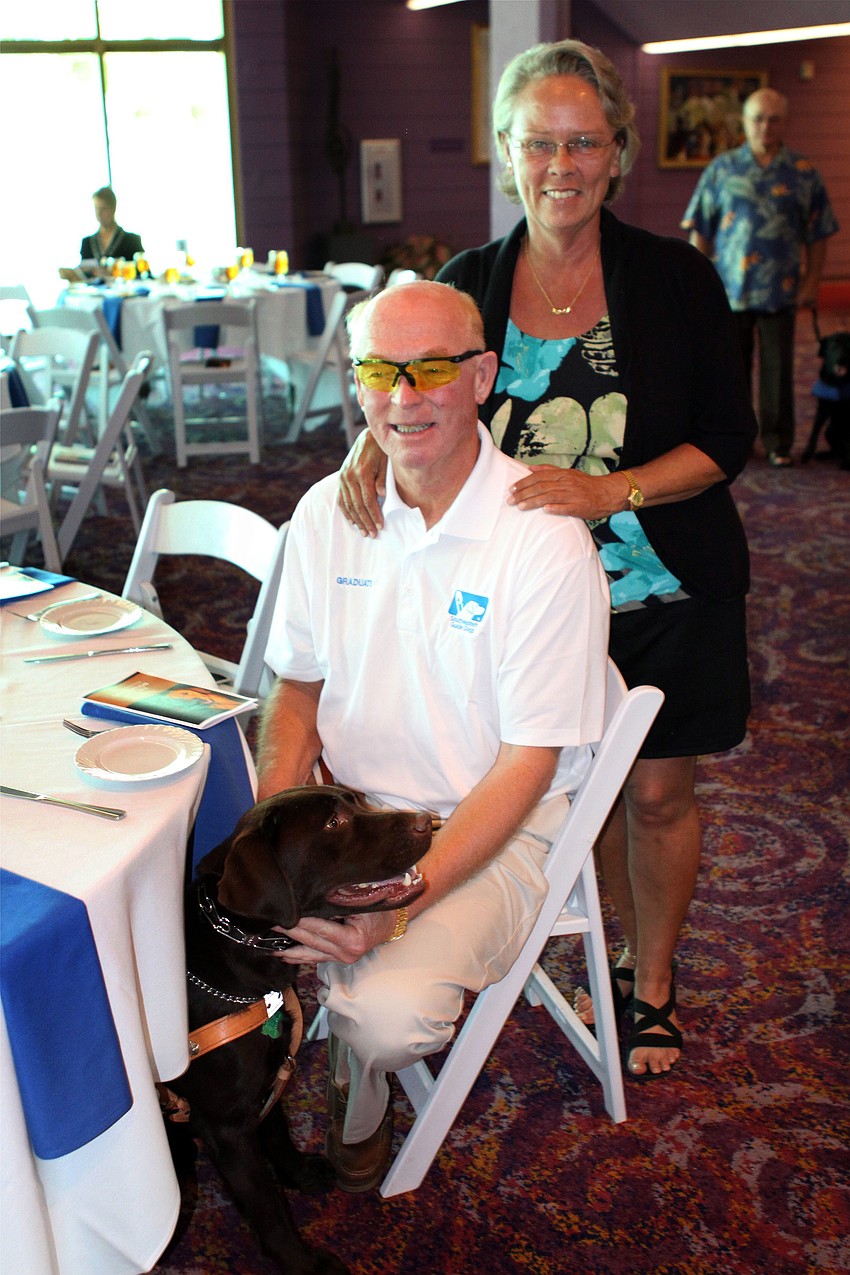 Bill Shearon and Tjet Martin with Shearonâ€™s new guide dog, Reese, the first chocolate lab to graduate from Southeastern Guide Dogs.