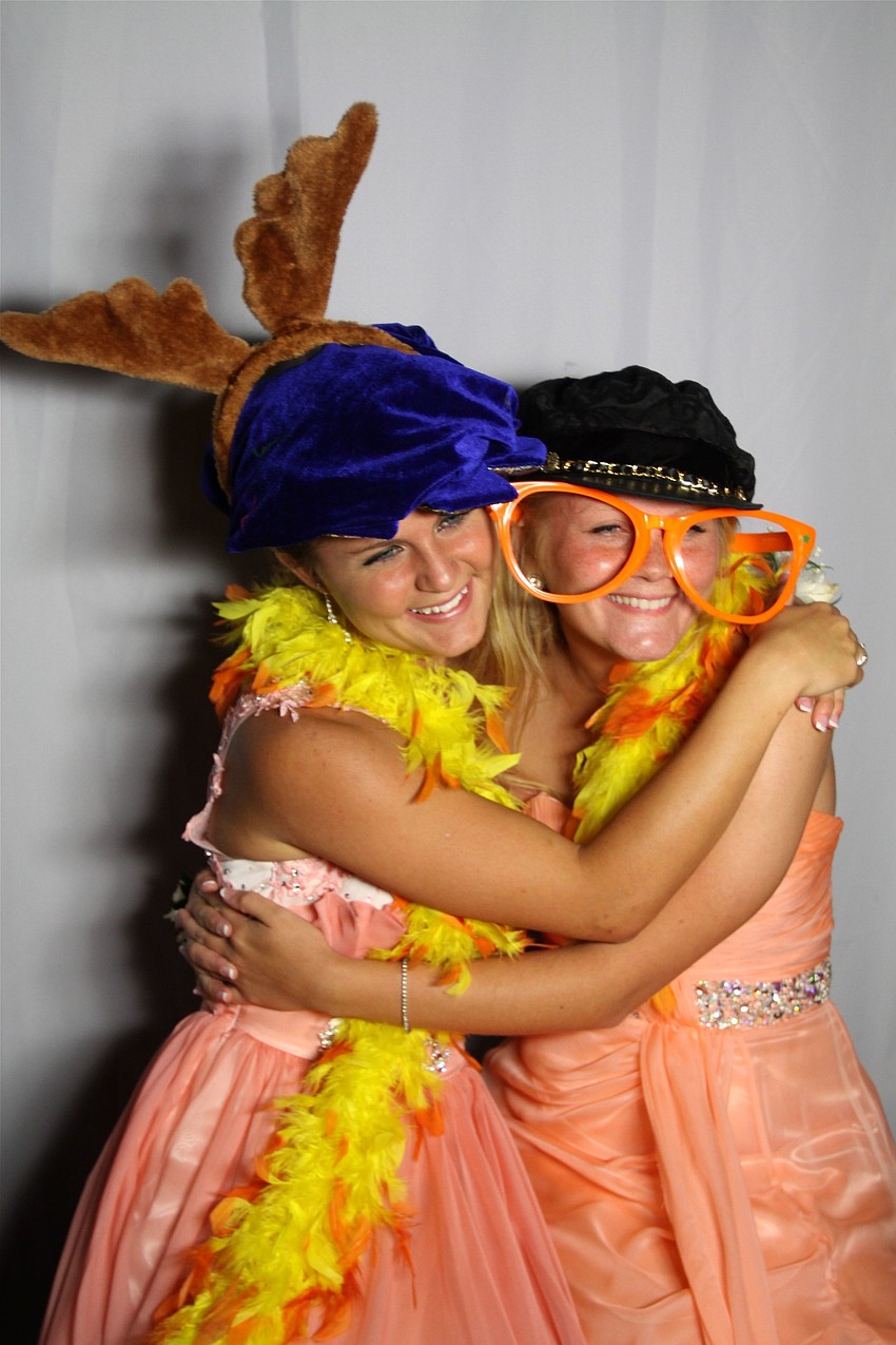 Delaney Brooks and Courtney Dust have fun having their pictures taken in the photo booth.