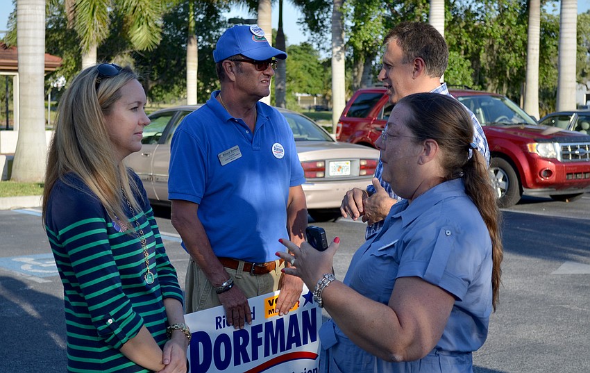 Richard Dorfman and supporter Valerie Dorr mingle with voters near the end of the day.