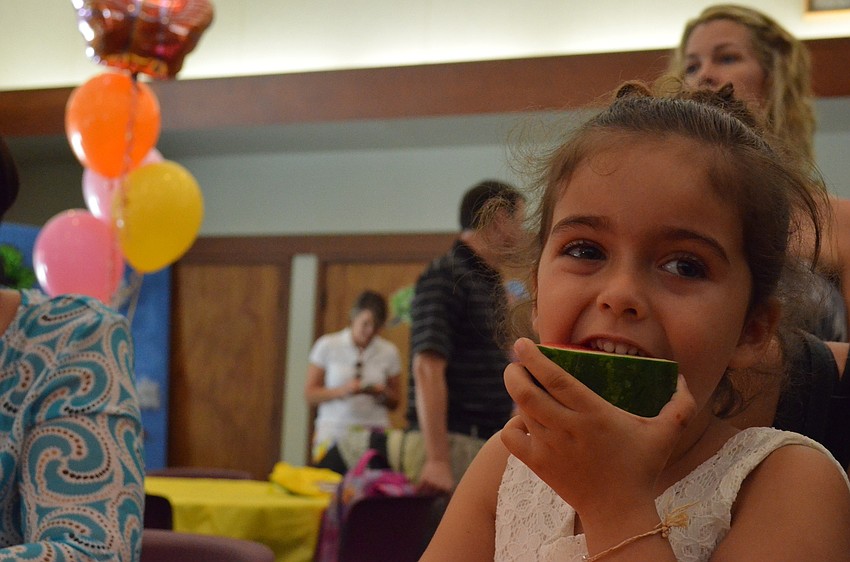 Lily Saba munches on some refreshing watermelon.