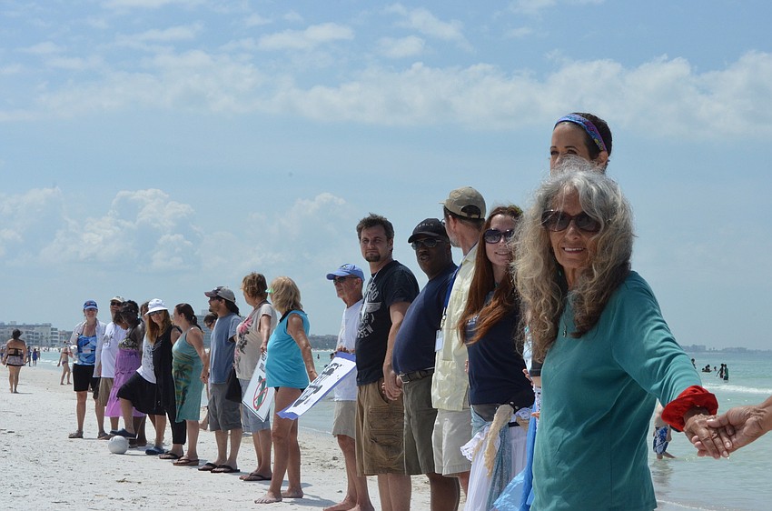 Sheila Golden and community members show their support for banning off shore drilling on Siesta Key Beach.