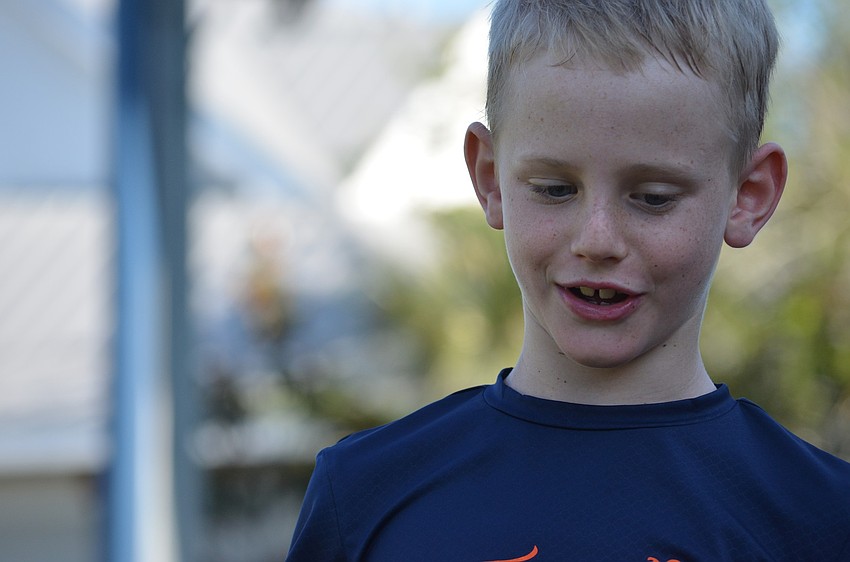 James G. contemplates whom to choose for the game of duck duck goose