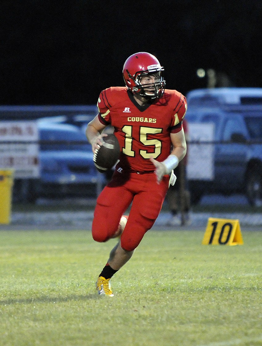 Cardinal Mooney quarterback Reese Vita scrambles for yardage in the second half.