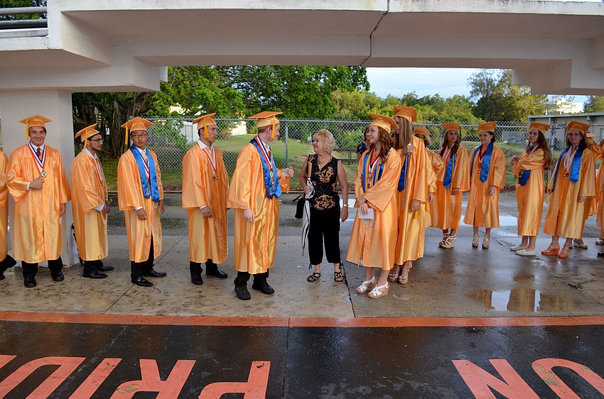 The boysâ€™ and girlsâ€™ lines meet near the entrance of the Sarasota High School football field.