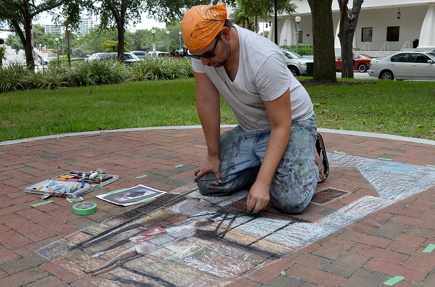 Truman Adams recreates a portrait with chalk.