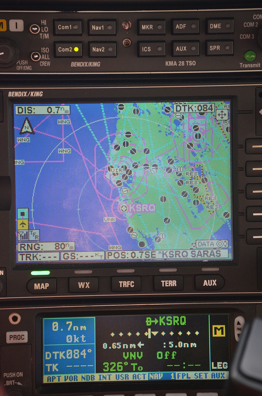 Pilot Jeff Walston shows kids the navigational map and explains how it works.