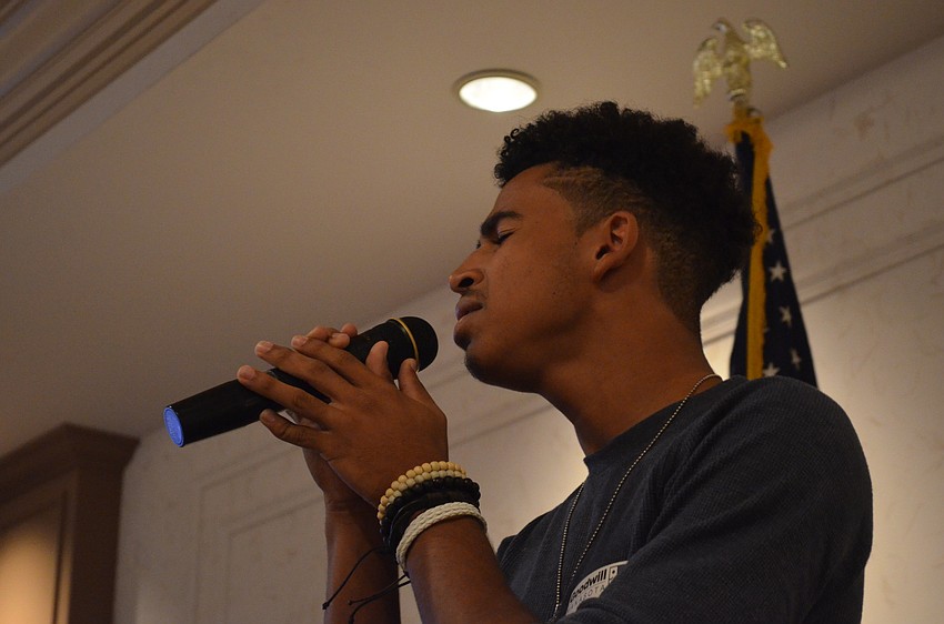 Goodwill Youth Ambassador Chris Eisenberg sings the National Anthem.