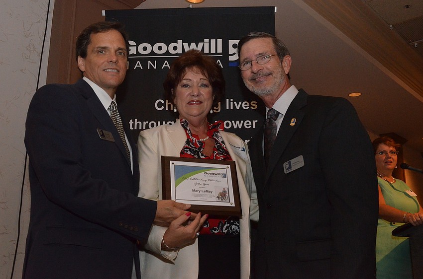 Rick Hughes and Bob Rosinsky present Mary LeMay with the 2013 Outstanding Volunteer of the Year award.