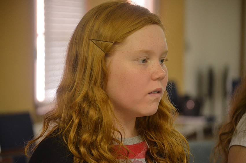 Mykayla Krom listens to instructions from Maestro Jesse Martin in chorus class.