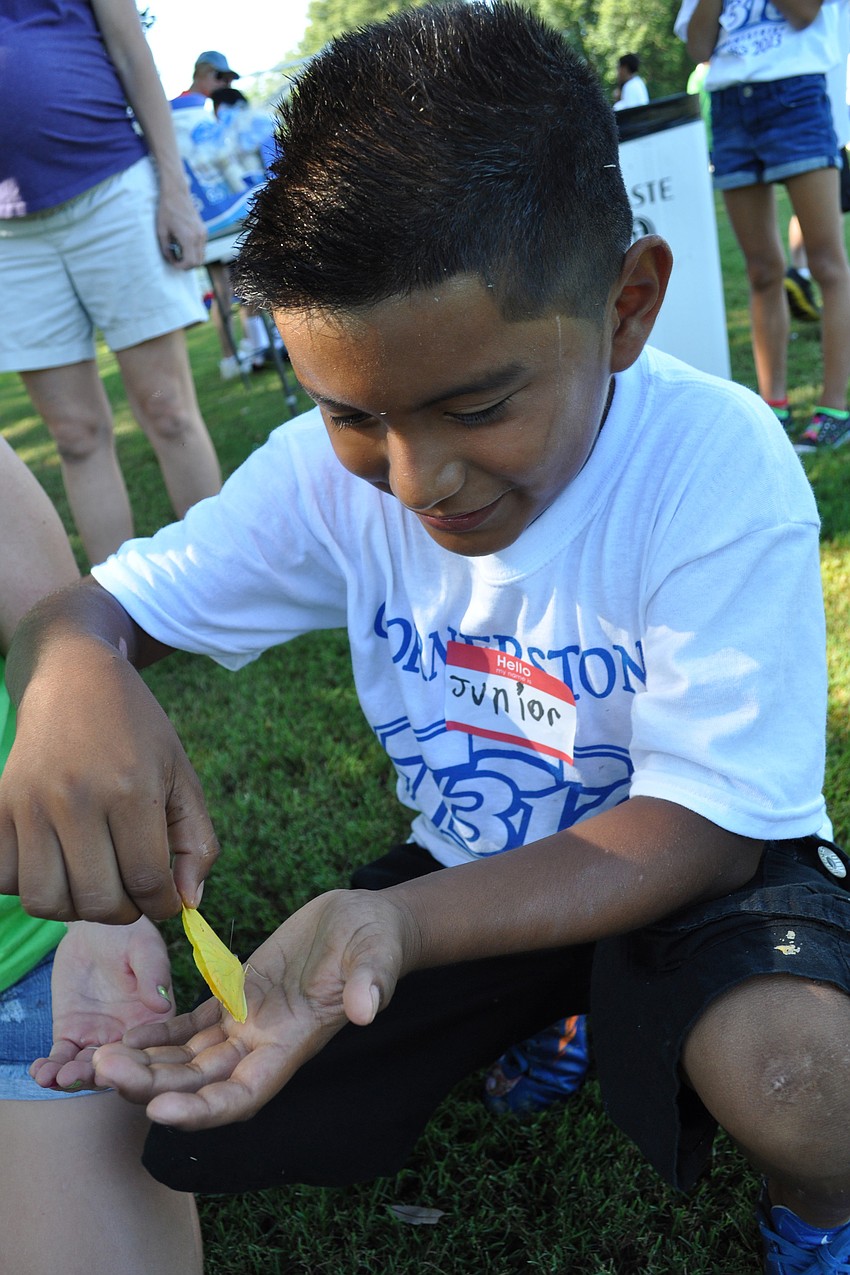 Junior Hernandez finds a yellow butterfly during a water break.