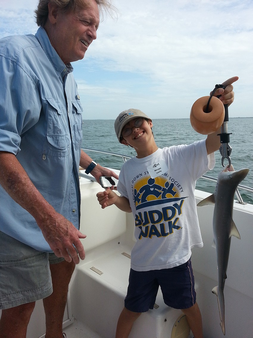 Morgan Leslie is excited to catch a small shark.