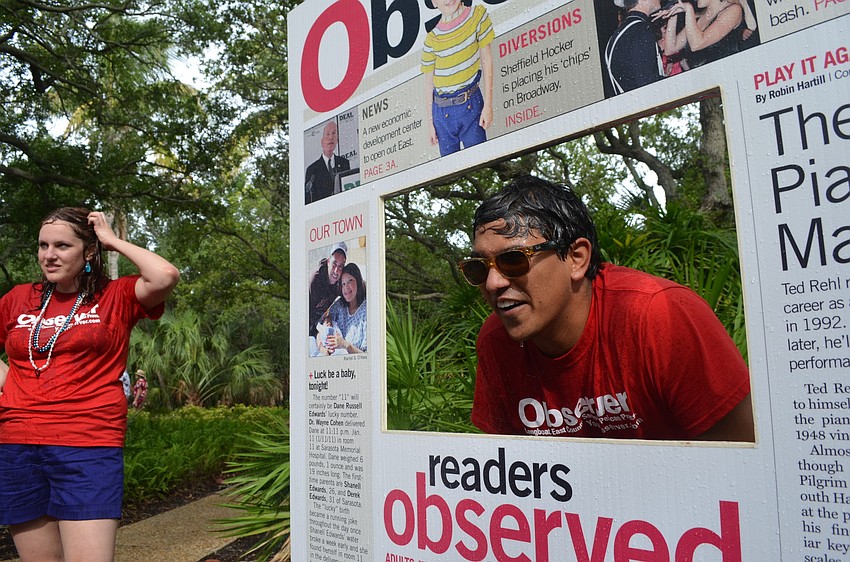 Digital Content Producer Alex Mahadevan braces himself as children take turns spraying him with water.