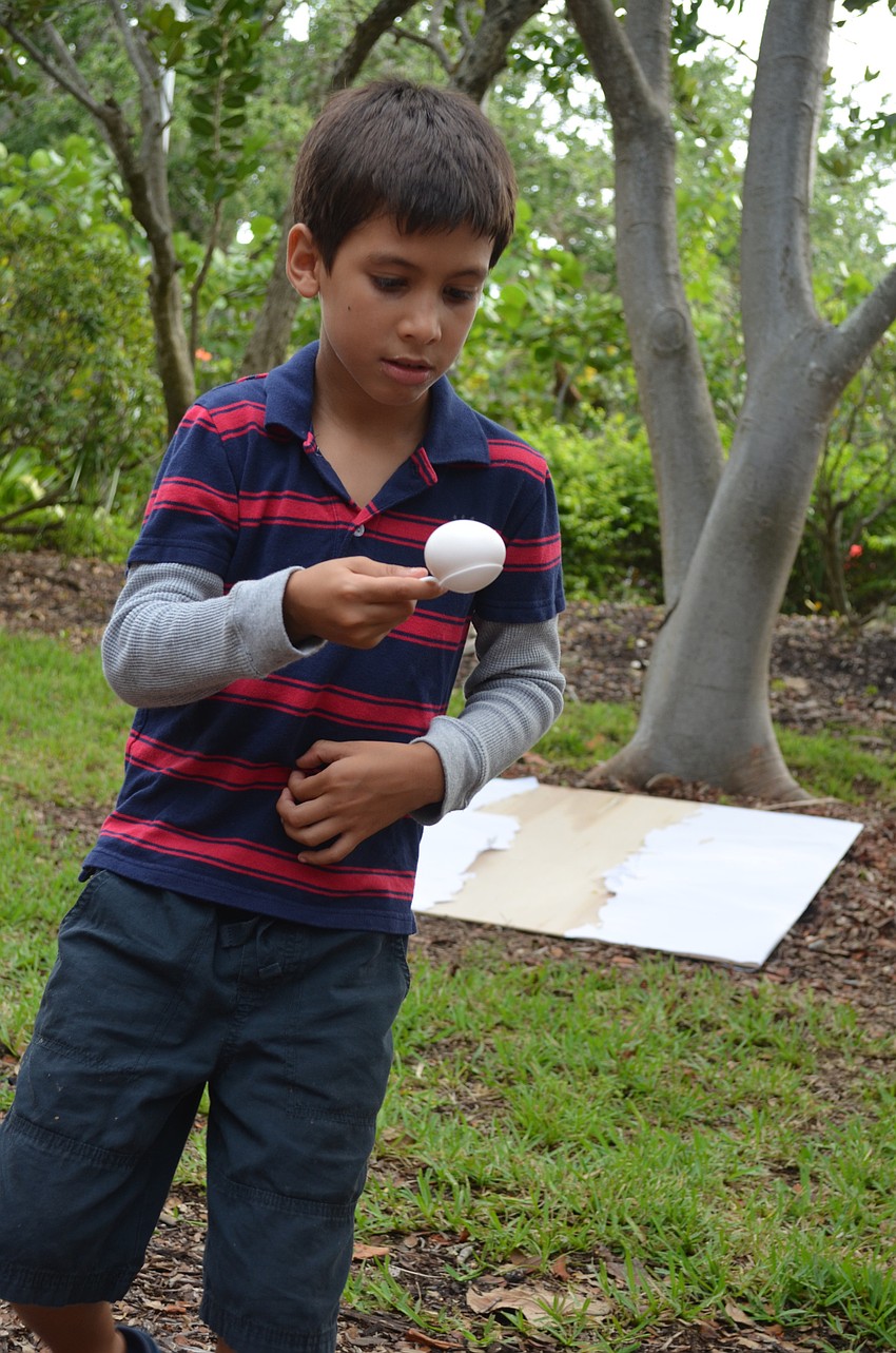 Marcel Trujillo, 8, carefully balances the egg in the egg and spoon race.