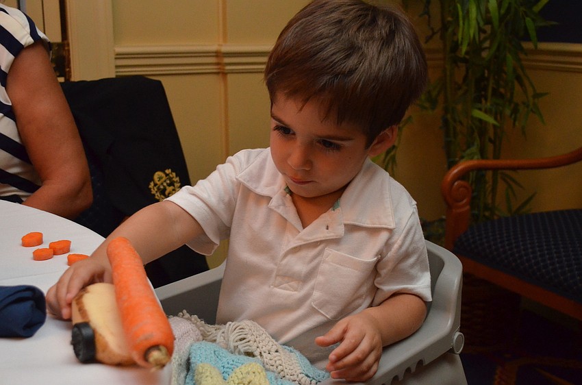 Cameron Vidal plays with his potato-car