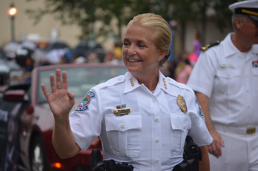 Police Chief Bernadette DiPino waves to the crowd as she walks in the parade.