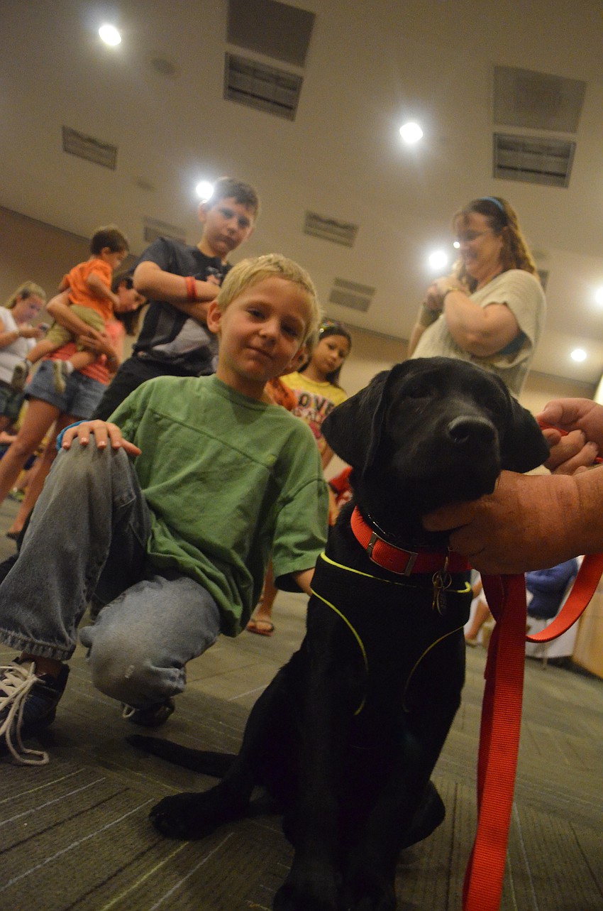 Christopher Rudolph, 6, visits with rescue pup in training Kaleb.