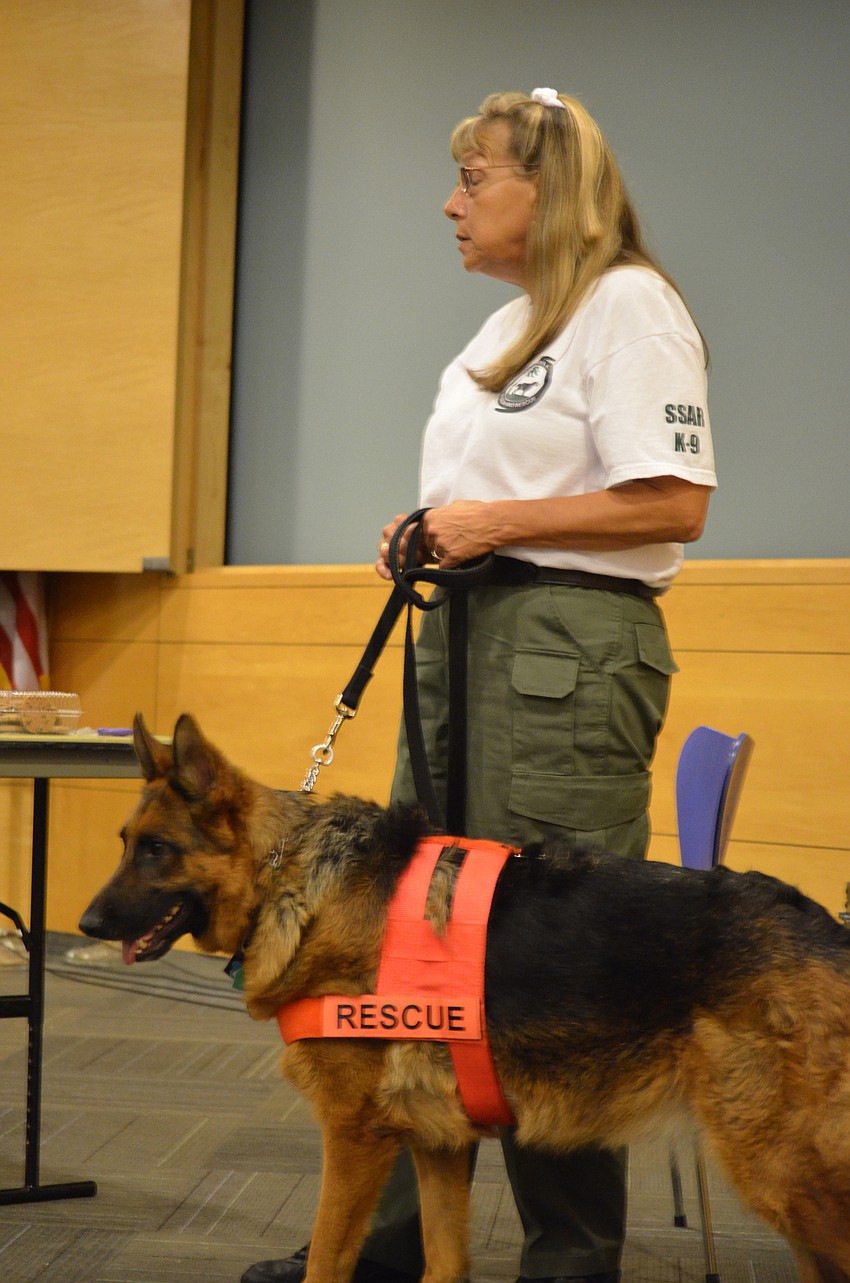 Pat Abrams shows Ayden Shapoiro, 7, how to feed Search & Rescue K-9 Ana.