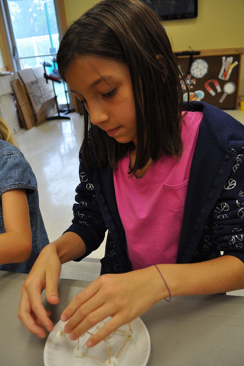 Nicole Stratford, 10, decides to build a walkway with her toothpicks, popsicle sticks and marshmallows.