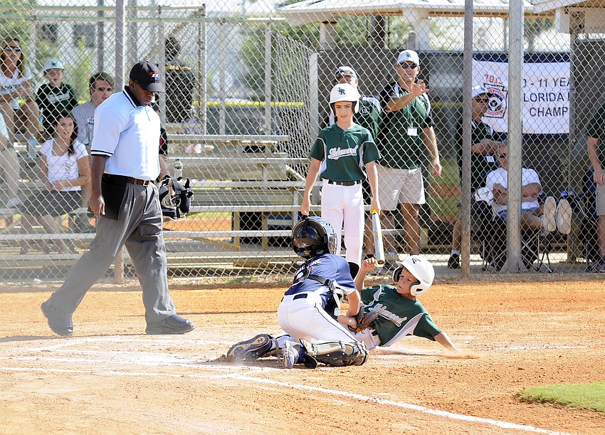 Connor Shine is called out at home plate in the first inning against New Tampa July 13.