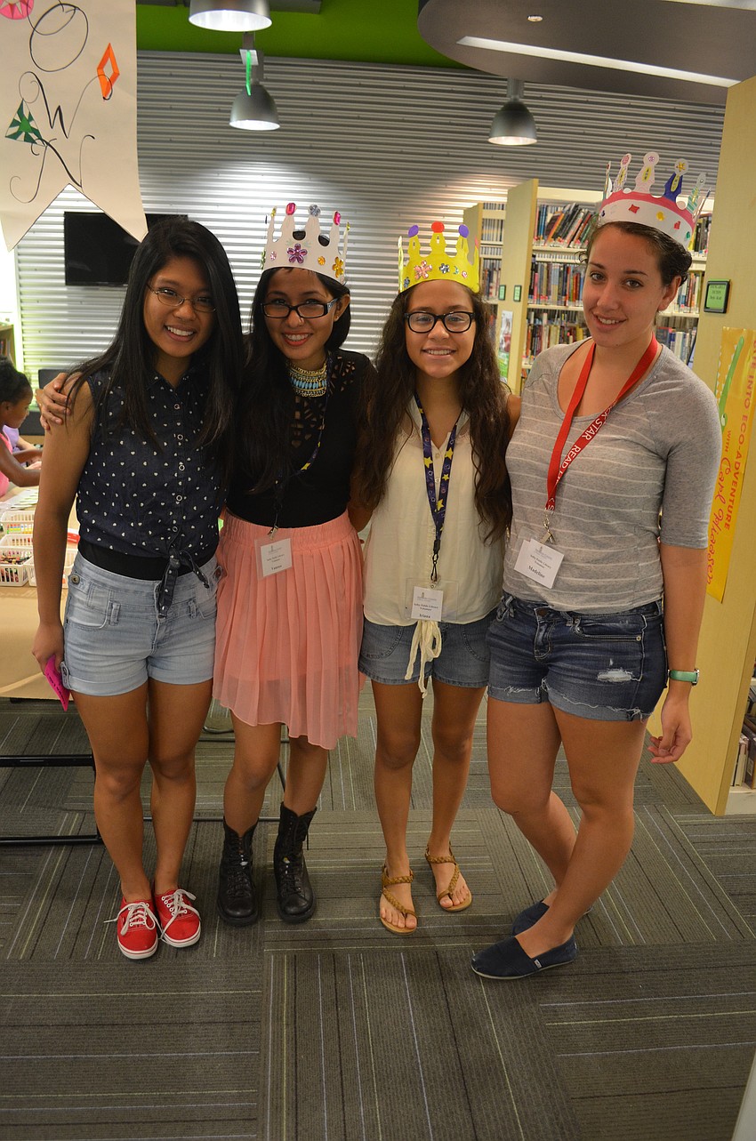 Volunteers Pauline Lopez, Vanessa Solis, Iriana Castillo and Madeline Black volunteer to help children make crafts at the crown table.