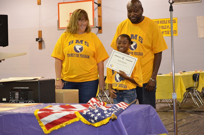 Louise Viverito and Henderson Riley present a math award to Jaela Dennis.