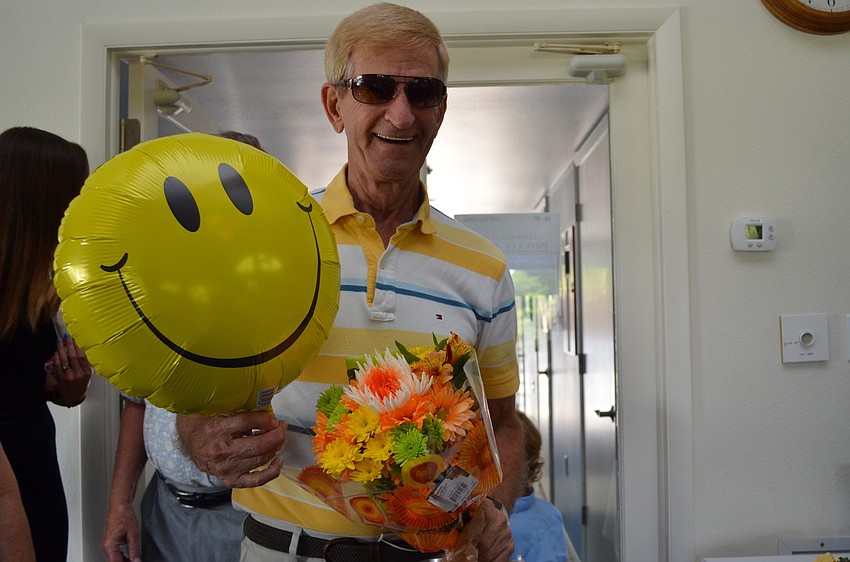 Mike Hodges brings a balloon and flowers for Pennie Williams