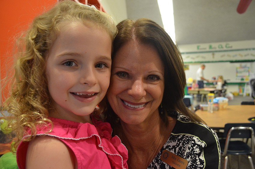 Kennedy Flatch, 7, is entering second grade. She visits with her first grade teacher Lynn Geers.