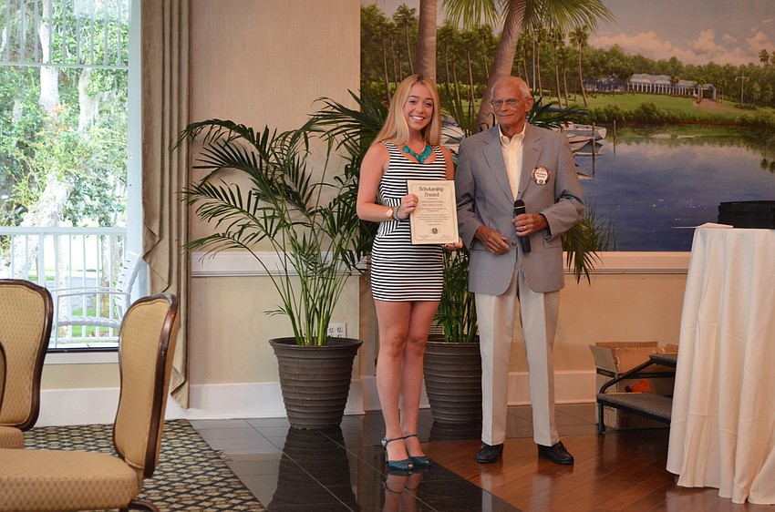 SCF student Lauren Nielsen accepts her scholarship certificate from Weldon Frost.