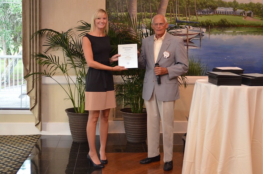 Amanda Peebles accepts her scholarship certificate from Weldon Frost.
