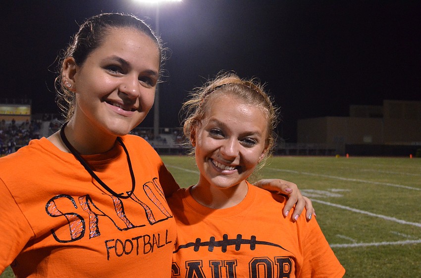 Sarasota High School seniors and student trainers Ciara Garden and Sierra Butler bring water to the players.