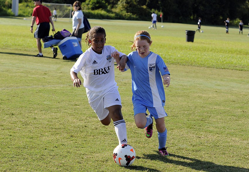 Florida Krush Blackâ€™s Kayla Banks attempts to push the ball past FC Floridaâ€™s Mary Brown.