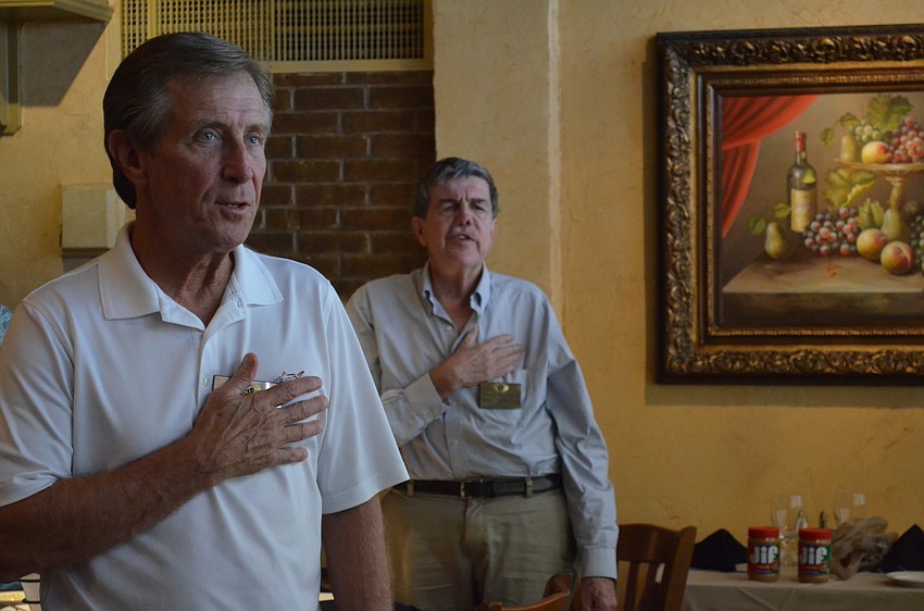 Members Ed Zentz and Douglas Griffin say the Pledge of Allegiance.