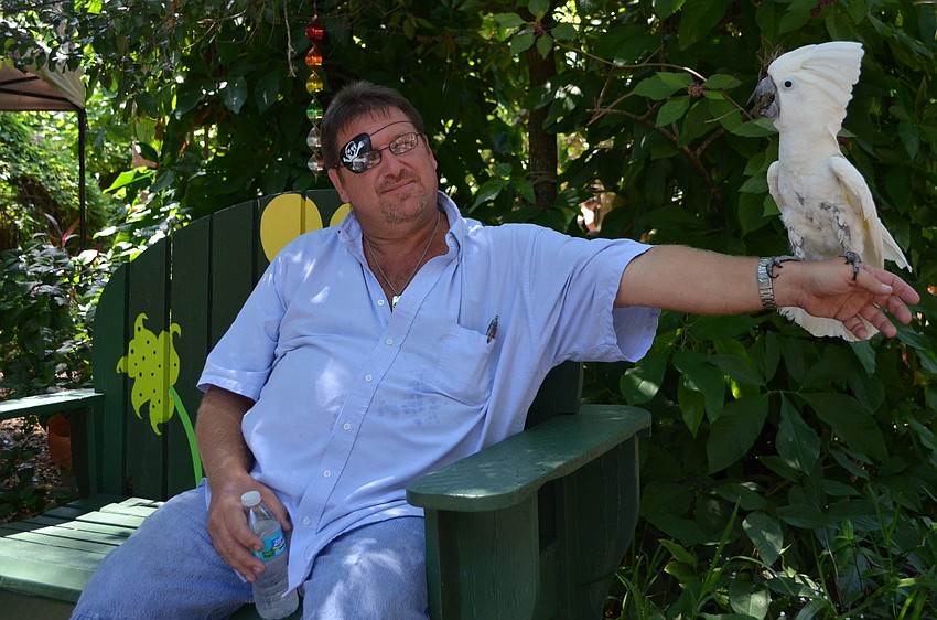 Bud Howell and Wyatt the cockatoo.