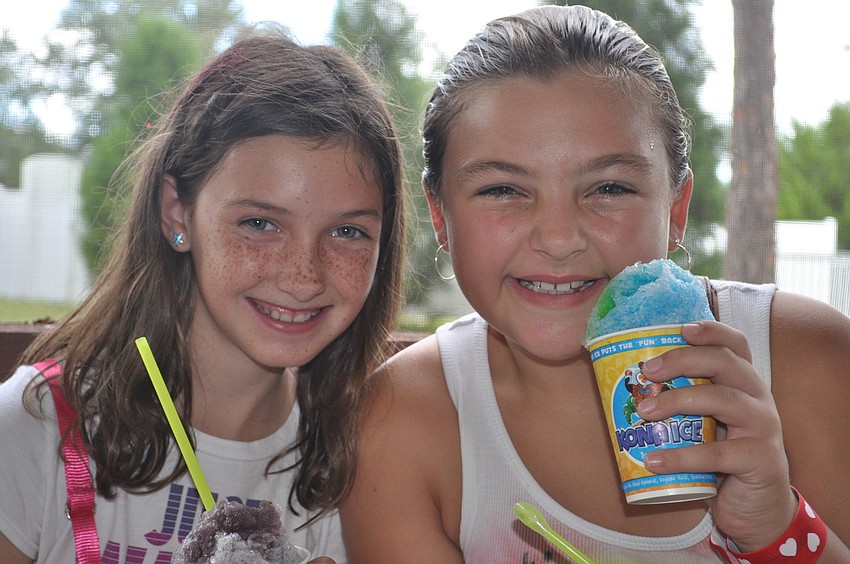 Emma Tullio and Katie Kelly cool off with snow cones