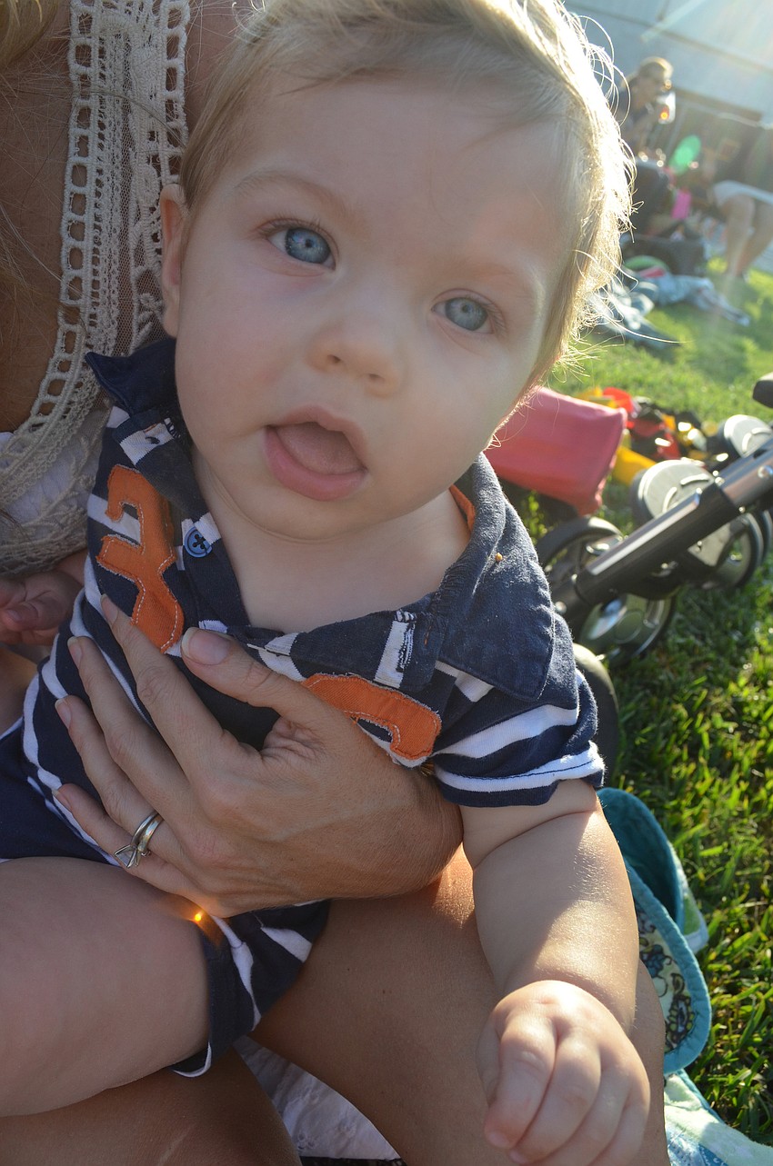 Eight-month old Brooks Wyckoff plays with his mother Christine at the tailgate.