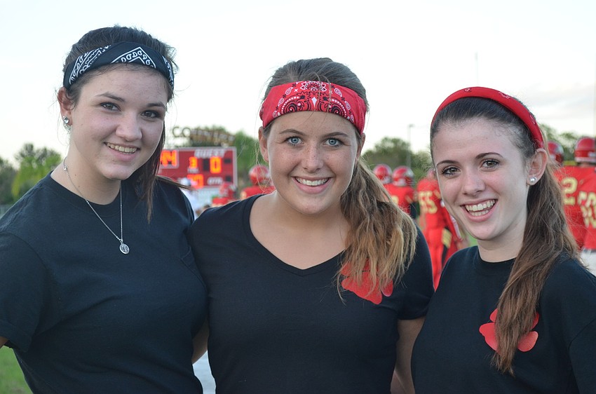 Water girls Brooke Peterson, 16, Emily Reynolds, 16 and Danielle Spina, 15, get water to the players so they can stay hydrated.