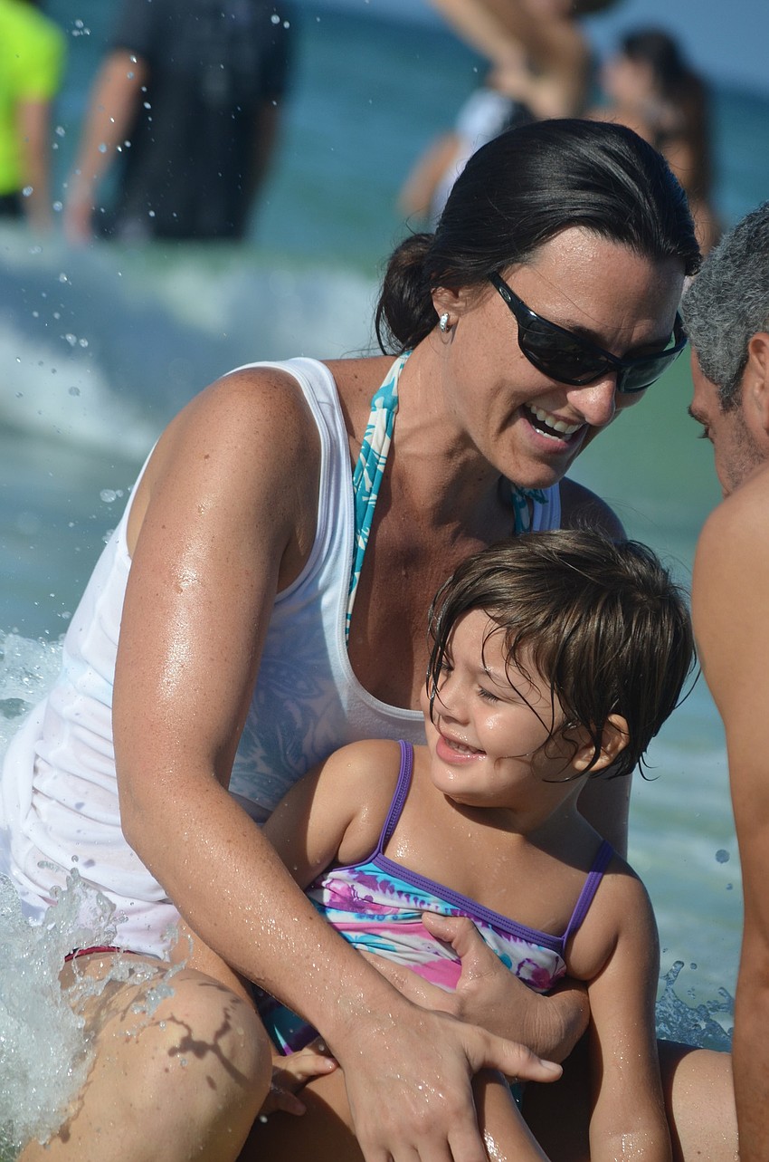 Pinnacle Academy Program Supervisor Michelle Chrzczonowski surfs out with student Jackie Gadeaun, 4.