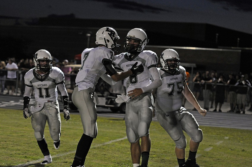 Lakewood Ranchâ€™s J.T. Fischer, Trevor Losada, Chad Rex and Kyle Mathis celebrate following Rexâ€™s 15-yard touchdown run.