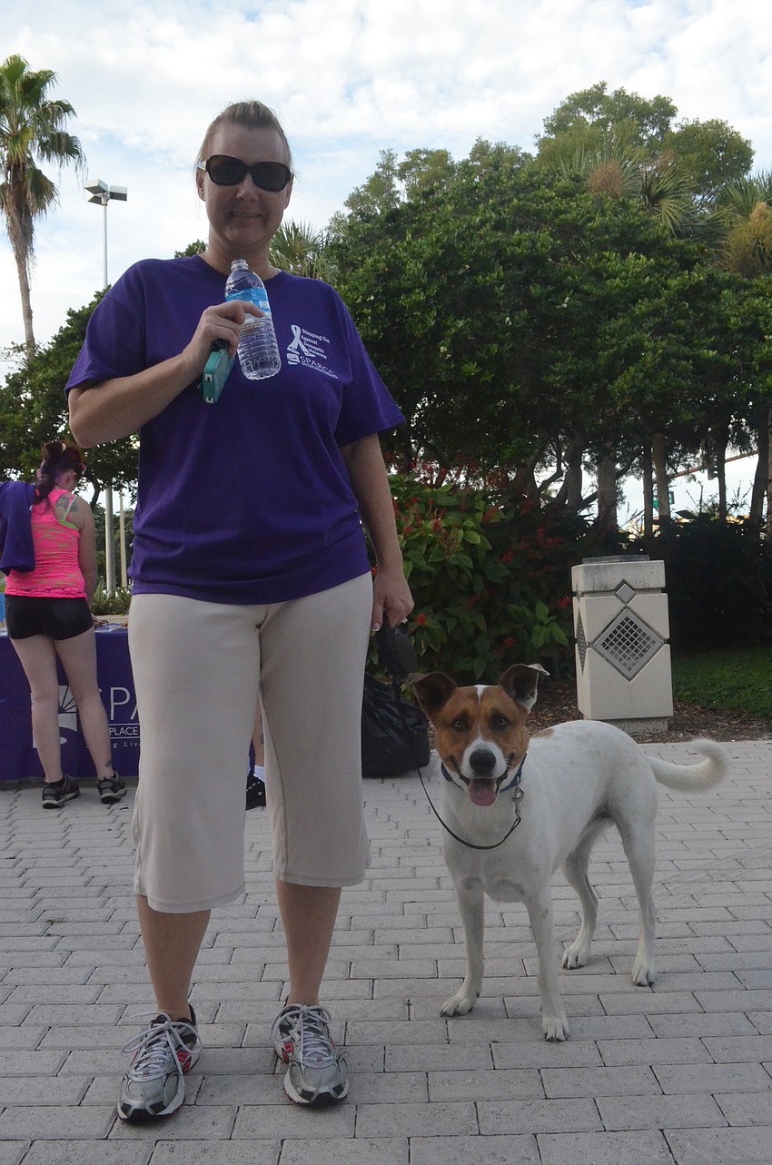 Mollie Cool and her 4-year old dog Gator walk against domestic violence.